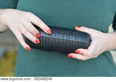 Young Girl Holds Nomi Black Portable Usb Speaker By Nomi Electronics Company. New Outstanding Mobile