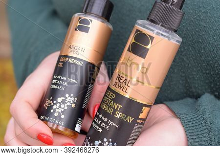 Young Girl Holds Estima Products. Estima Argan Jewel Deep Repair Oil And Real Jewel Deep Instant Rep