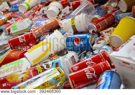 Many Wrappings And Cans From Used Products By Famous Worldwide Brands. Pattern Of Trash Of Various C