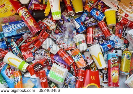 Many Wrappings And Cans From Used Products By Famous Worldwide Brands. Pattern Of Trash Of Various C