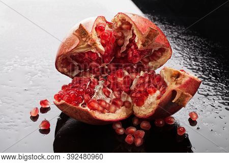 Pomegranate On A Glass Background With Drops Of Water