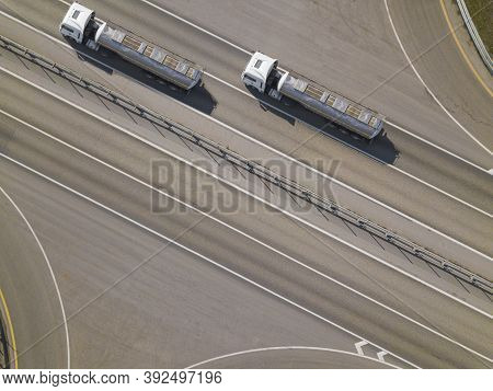 Aerial Top Down Shot Of Highway With Oil Truck Trailers.