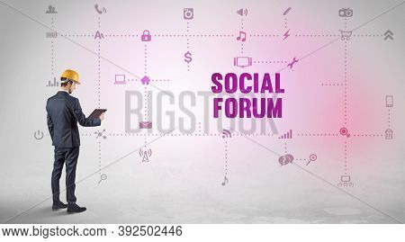 Engineer working on a new social media platform with SOCIAL FORUM inscription concept