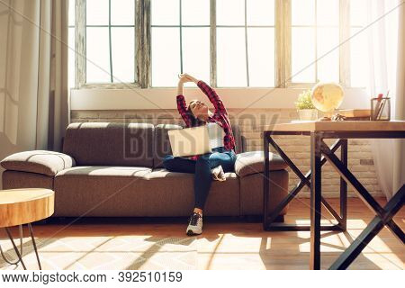 Woman Teleworker Works At Home With A Laptop. She Is In Smart Working Due To Covid-19 Pandemic