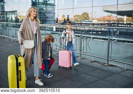 Mother Going To The Airport With Her Kids