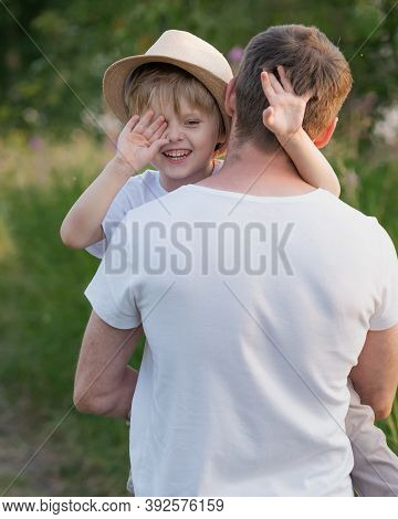 Portrait Of Fathe And Son At Meadow In Summer Day