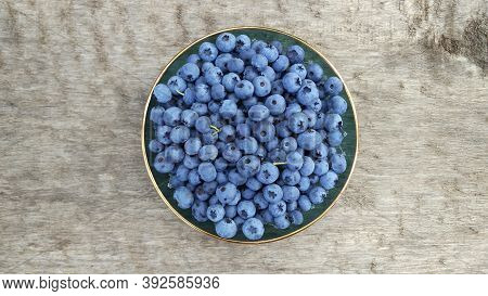 Bright, Juicy, Tasty, Blueberries In A Plate On A Wooden Table Top.