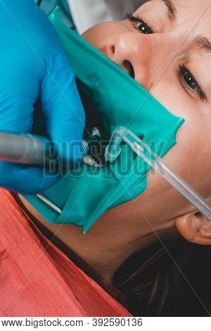Dentist Treats The Tooth With Modern Methods, Uses A Rubber Dam, Sterile Tooth Treatment.
