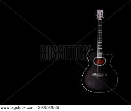 Black Acoustic Guitar Subtly Illuminated With The Inner In Red Color On A Black Background , Copy Sp