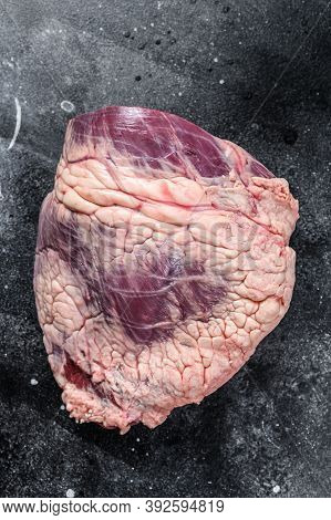 Fresh Raw Beef Liver Offal. Black Background. Top View