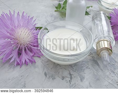 Cream Cosmetic Flower On Concrete Background  Essence