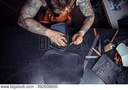 Artisan Working With Leather Working With Leatherwork At His Workshelf