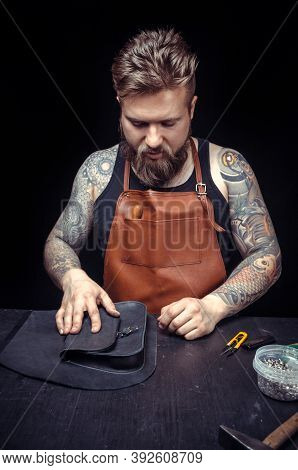 Skinner Demostrating Leather Cutting Process In Leather Shop