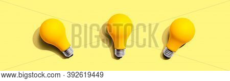 Three Yellow Light Bulbs - Flat Lay From Above