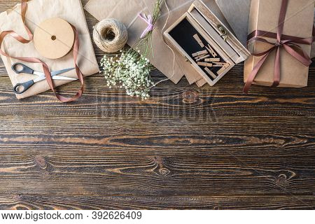 Craft Paper And Tools For Creating And Decorating Gift Packaging. There Is Cardboard, Brown Ribbons 