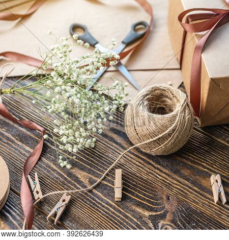 Craft Paper And Tools For Creating And Decorating Gift Packaging. There Is Cardboard, Brown Ribbons 