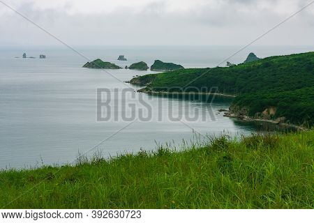 Bay Of The Sea From The Top Of A Hill Of A Mountainous Coast With An Island In The Background, Summe