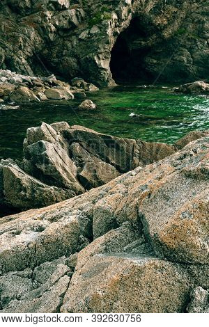 Rocks And Grotto On The Seashore, Cloudy Weather At Sea, Coastline Of Telyakovsky Bay Primorsky Krai