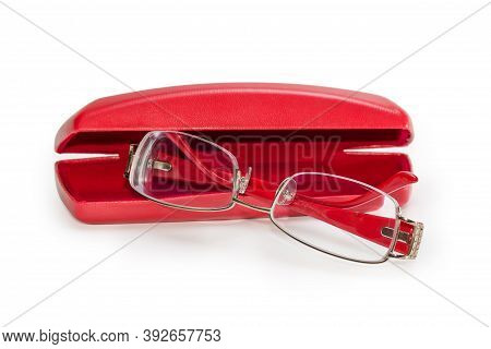 Modern Eyeglasses For Women In Metal Yellow Rim With Red Plastic Earpieces Against The Partly Open R