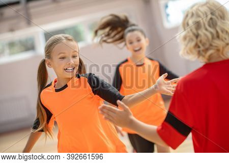 Kids In Bright Sportswear Enjoying Training In The Gym
