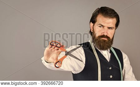 Handsome Tailor In White Shirt. Amazing Atelier With Antique Furniture. Tailor-made Custom-made Suit