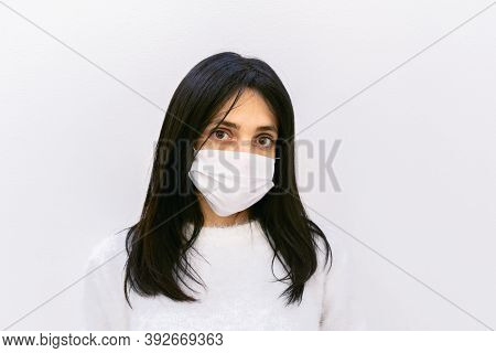 Close Up Face Of Young Brunette Caucasian Woman Looking Straight To Camera Calmly And Seriously Isol