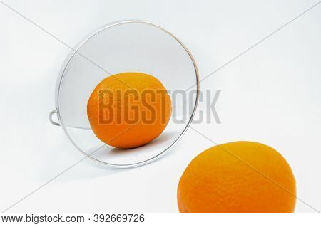 Reflection Of Orange With Thick Peel In Cosmetic Mirror On White Background. Metaphor Of Cellulite T