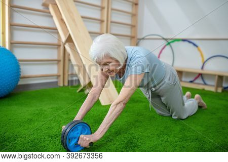 Elderly Woman Exercising In A Rehabilitation Center