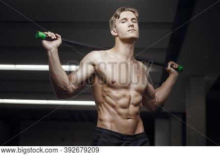 Fitness Man At Workout In Gym With Bodybar Stretching Muscles. Workout Fitness And Bodybuilding Heal