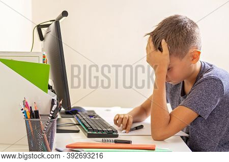 Kid With Computer Doing Homework At Home. Learning Difficulties, Online Learning, Education Concept