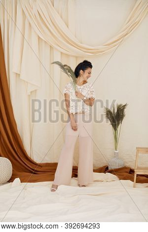 Fashion Art Photo Of Brunette Woman In Studio Interior. Soft Light. Full Lenth Photo. Trendy Fabric 