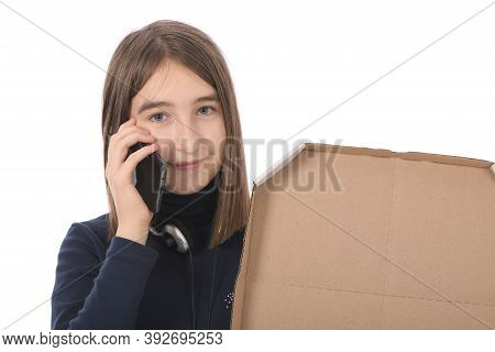 Pre-adolescent Girl Called On Black Smartphone. Isolated On White Background. High Resolution Photo.