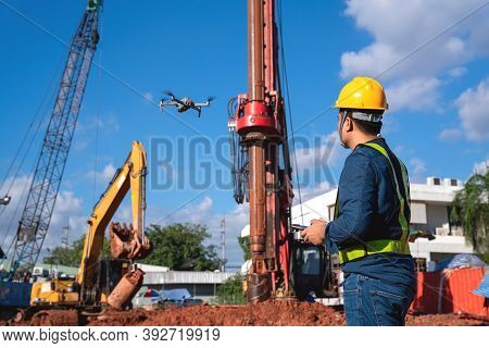 Drone Inspection New Construction Site. Operator Inspecting New Construction Site Control By Civil E