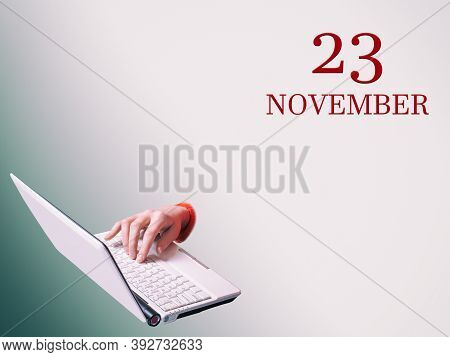 23th Of November. A Hand Is Typing On A Laptop The Announcement Of The Date Of A Business Meeting Or