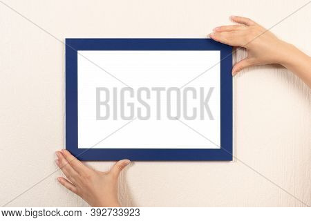 Mockup Diploma. Woman Hanging Photo Frame Mockup On Wall. Certificate, Diploma, Picture, Gratitude B