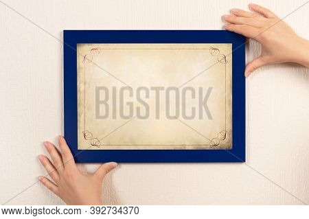 Mockup Diploma. Woman Hanging Photo Frame Mockup On Wall. Old Grunge Certificate With Vintage Orname