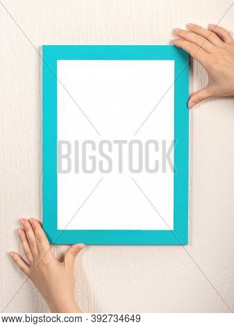 Mockup Diploma. Woman Hanging Photo Frame Mockup On Wall. Certificate, Diploma, Picture, Gratitude W