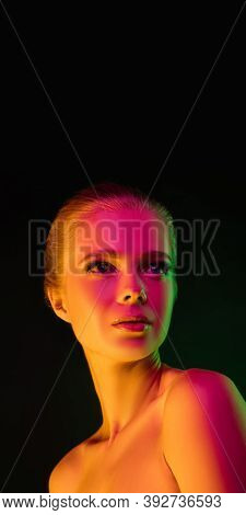 Mavelous. Portrait Of Fashion Model In Neon Light On Dark Studio Background. Beautiful Caucasian Wom