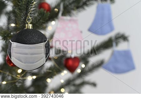 Celebration With Social Issuse Virus Corona Or Covid 19 Concept. Christmas Tree Ornament With Protec