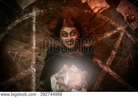 A portrait of a creepy witch in the wooden house. Magic, dark force, spell. 