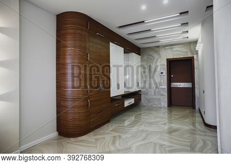 Wooden Cabinet In Modern Hallway Interior With Marble Floor