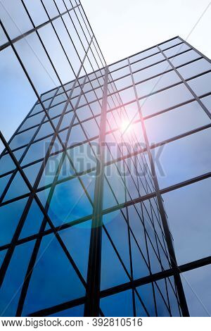 Tall modern building skyskraper windows reflecting sunlight