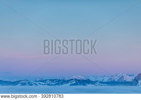 Splendid apline scenery. High mountains with fog and lovely evening light.
