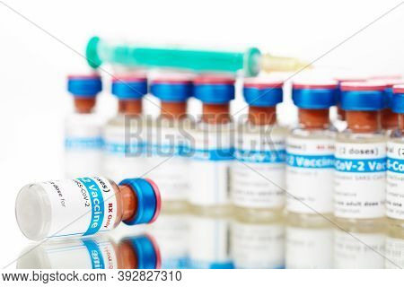 Bottles Of New Sars-cov-2 Vaccine On Table With Plastic Syringe