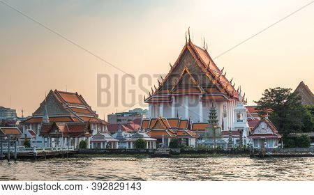 Wat Kanlayanamit In Bangkok, Thailand As Seen From The Boat Cruising The Chao Phraya River