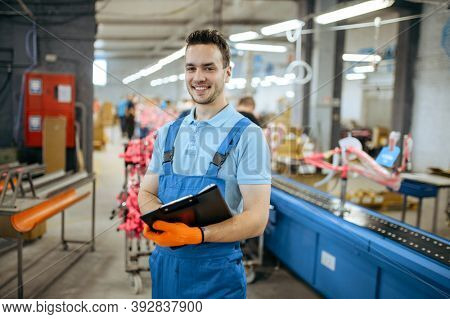 Bicycle factory, smiling worker at assembly line