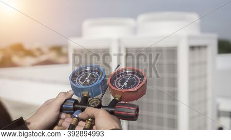 Air Repairman Technician Using Manifold Gauge Is Measuring Equipment For Filling Industrial Factory 