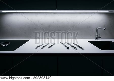 White Kitchen Worktop With Concrete Spatula On Wall And Illuminated Led Strip In Ceiling. There Is S