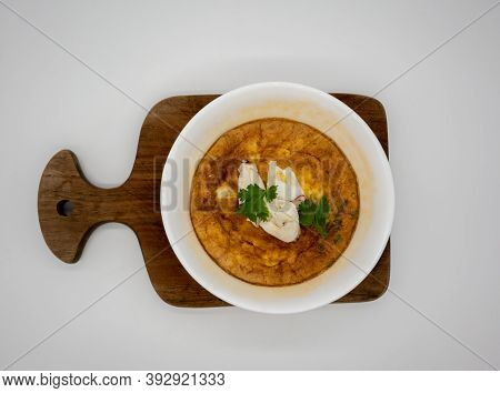 King Crab Omlet In White Ceramic Bowl On Wooden Plate Isolated On White