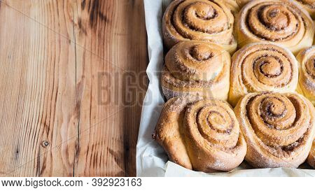 Freshly Baked Cinnamon Buns On Parchment Paper. Top View, Cpyspace. Sweet Homemade Pastry Christmas 